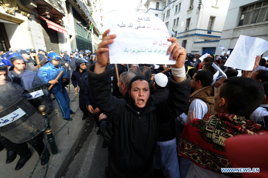 Algerian people protest against sarcastic cartoons on the Prophet of Islam Muhammad, which have been published in the latest edition of French weekly Charlie Hebdo, in the capital city of Algiers, Algeria, Jan. 16, 2015.