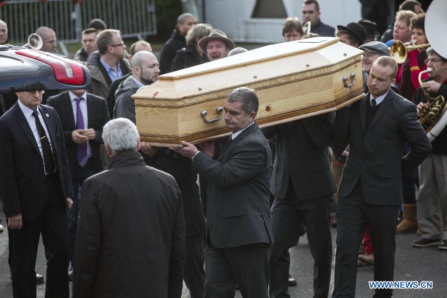 People attend the funeral of slain Charlie Hebdo editor-in-chief Stephane Charbonnier (who publishes under the pen name Charb) in Pontoise, outside Paris, Jan. 16, 2015.