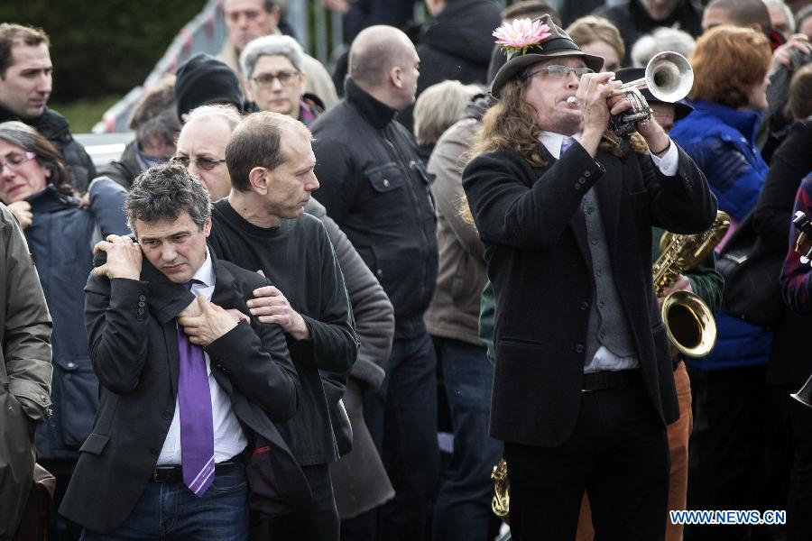 People attend the funeral of slain Charlie Hebdo editor-in-chief Stephane Charbonnier (who publishes under the pen name Charb) in Pontoise, outside Paris, Jan. 16, 2015.