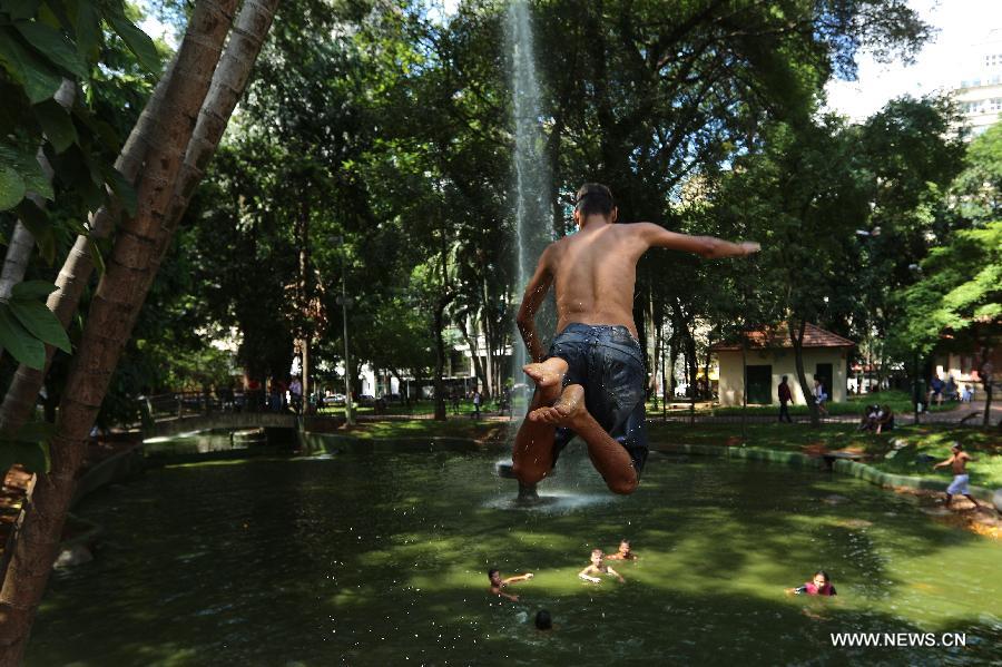 A boy jumps into a public fountain to cool off in downtown Sao Paulo, Brazil, on Jan. 19, 2015. 