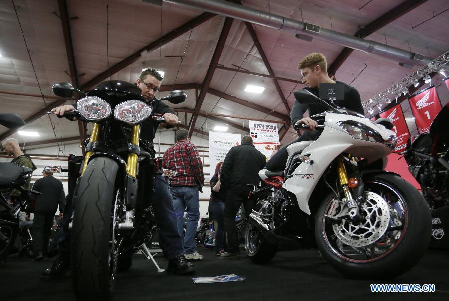 Visitors check out the new motorcycles displayed at the Vancouver International Motorcycle Show at Tradex center in Abbotsford, Canada, Jan. 23, 2015. 