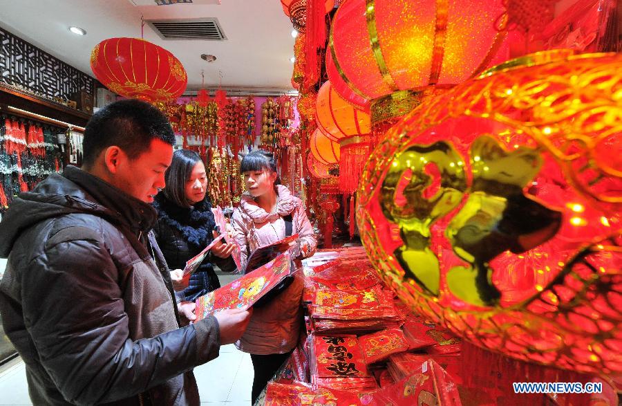 People select couplets and lanterns at a shopping mall in Yinchuan, capital of northwest China's Ningxia Hui Autonomous Region, Feb. 2, 2015.