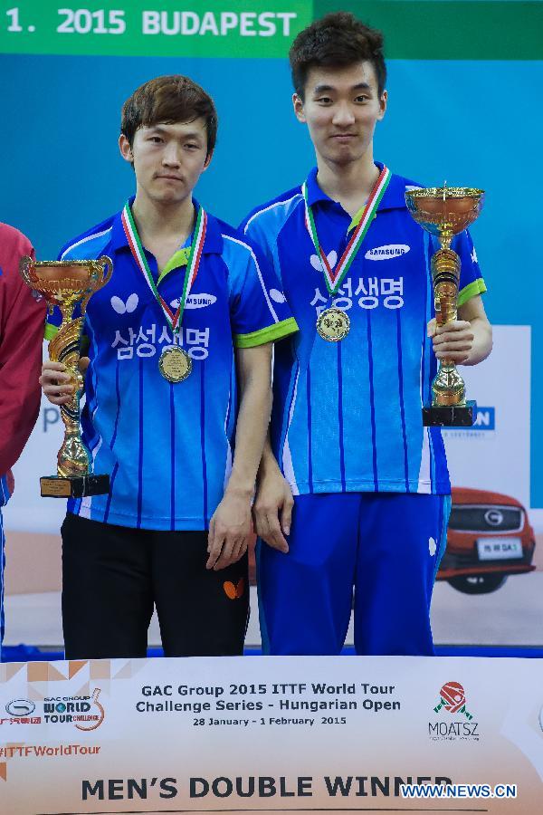 Gold medalists Jeong Sangeun (L) and Lee Sangsu of South Korea attend the awarding ceremony of the men's doubles of the GAC Group 2015 ITTF World Tour Hungary Open in Budapest, Hungary on Feb. 1, 2015. Jeong Sangeun and Lee Sangsu beat the Russian duo of Viachaslev Burov and Alexey Liventsov 3-1 to win the men's doubles title. (Xinhua/Attila Volgyi) 