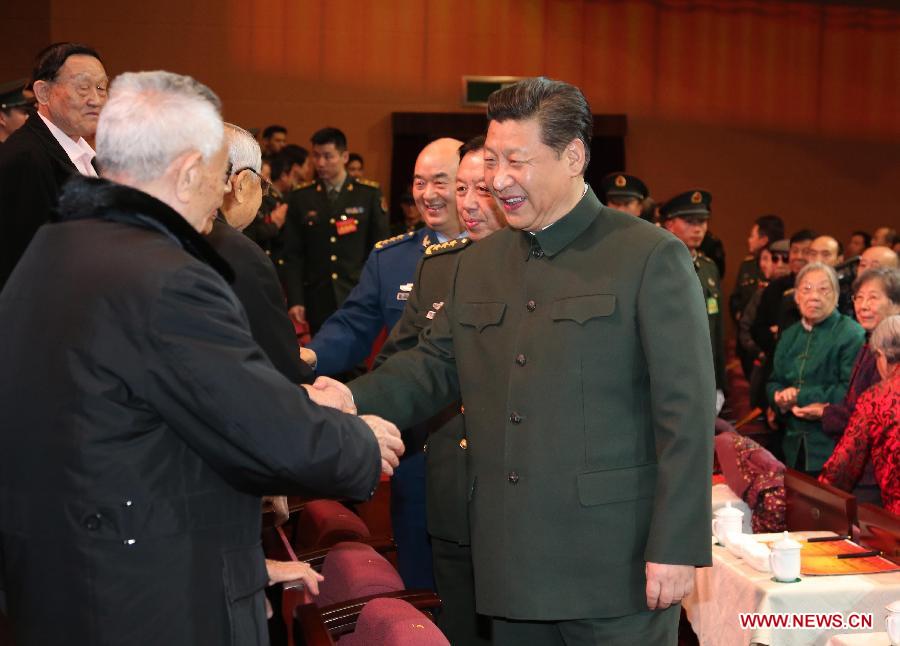 Chinese President Xi Jinping (R, front), also general secretary of the Communist Party of China (CPC) Central Committee and chairman of the Central Military Commission, attends a festive art performance to extend Spring Festival greetings to military veterans and ex-officers in Beijing, capital of China, Feb. 9, 2015.