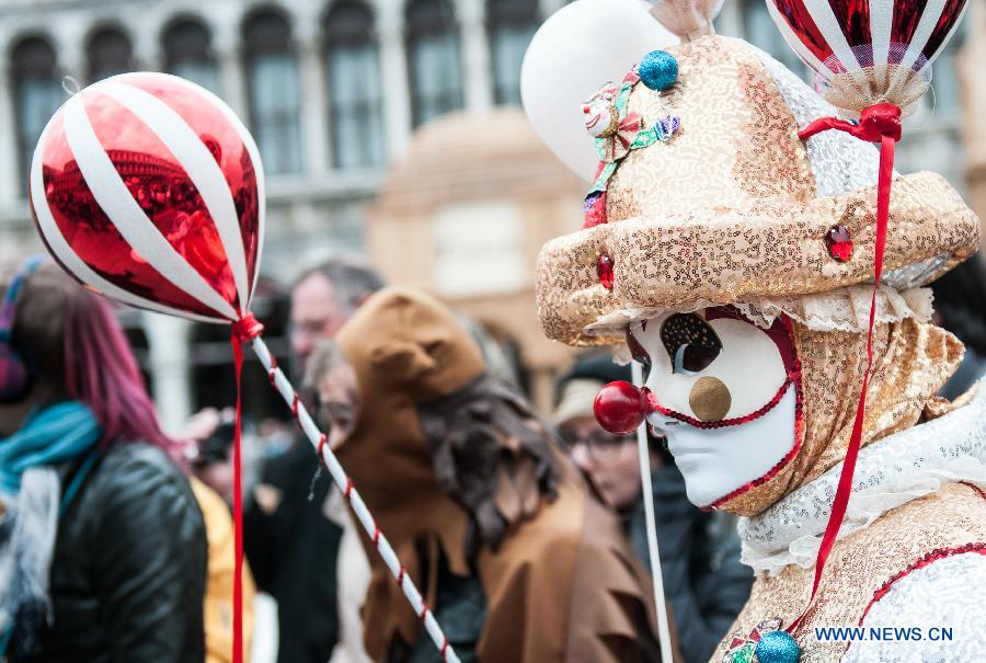A costumed reveller poses during the Venice Carnival in Venice, Italy, on February 13, 2015.