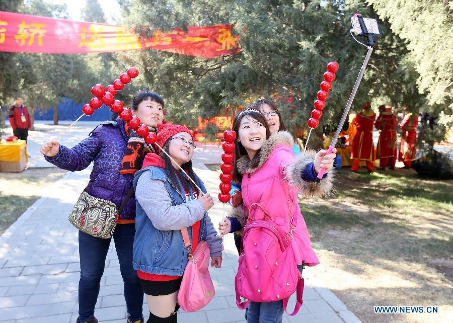 Visitors take a selfie at the annual temple fair at Ditan Park, also known as the Temple of Earth, Feb. 18, 2015.