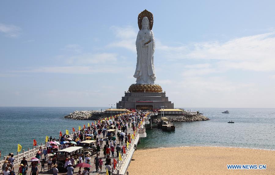 Photo taken on Feb. 23, 2015 shows people visiting a Buddhist scenic spot in Sanya City, south China's Hainan Province.