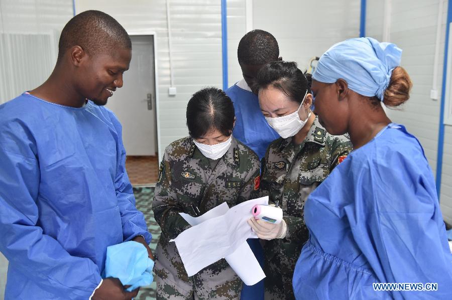 Local medical staff receive training from Chinese doctors on Ebola treatment in Monrovia, Liberia, Dec. 3, 2014. Since the outbreak of Ebola Virus Disease, China provided its aid in the first time and so far has sent successively several medical teams and four batches of emergency aid worth a total of 700 million yuan (around 112.2 million U.S. dollars) to the epidemic-hit countries, becoming one of the biggest donors to the infected areas and playing an important role in coping with the epidemic. (Xinhua/Yang Guoyu) 