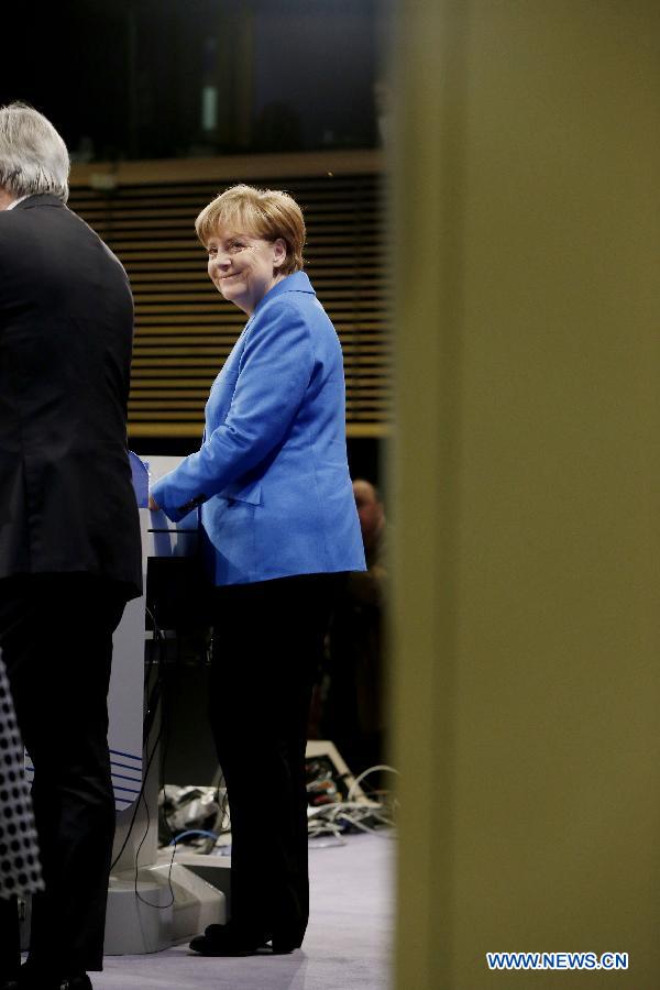 German Chancellor Angela Merkel (R) reacts during a press conference with European Commission President Jean-Claude Juncker at the end of her visit to the European Commission at the EU headquarters in Brussels, Belgium, on March 4, 2015.