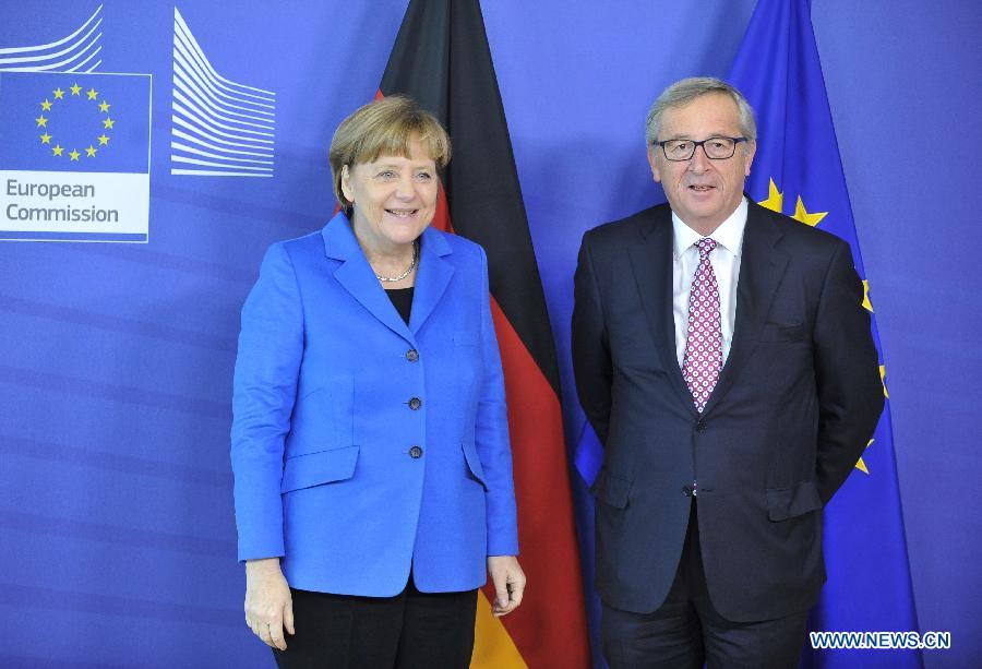 German Chancellor Angela Merkel (L) and European Commission President Jean-Claude Juncker pose for photos in Brussels, Belgium, on March 4, 2015. 