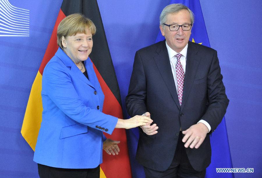 German Chancellor Angela Merkel (L) and European Commission President Jean-Claude Juncker pose for photos in Brussels, Belgium, on March 4, 2015. 