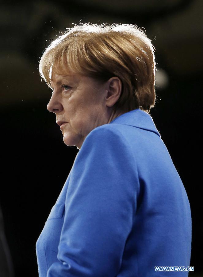 German Chancellor Angela Merkel looks on as European Commission President Jean-Claude Juncker (not seen) speaks during a press conference at the end of her visit to the European Commission at the EU headquarters in Brussels, Belgium, on March 4, 2015. 