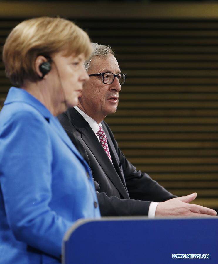 European Commission President Jean-Claude Juncker (R) speaks during a press conference with German Chancellor Angela Merkel at the end of her visit to the European Commission at the EU headquarters in Brussels, Belgium, on March 4, 2015. 