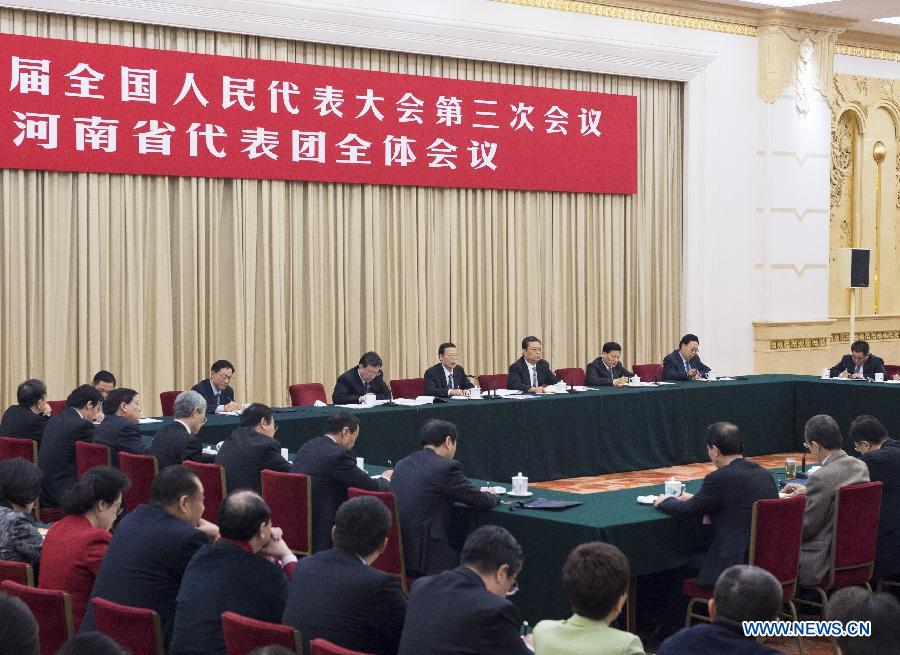 Chinese Vice Premier Zhang Gaoli (back C), also a member of the Standing Committee of the Political Bureau of the Communist Party of China Central Committee, joins a panel discussion with deputies to the 12th National People's Congress (NPC) from central China's Henan Province during the third session of the 12th NPC, in Beijing, capital of China, March 7, 2015. (Xinhua/Wang Ye) 