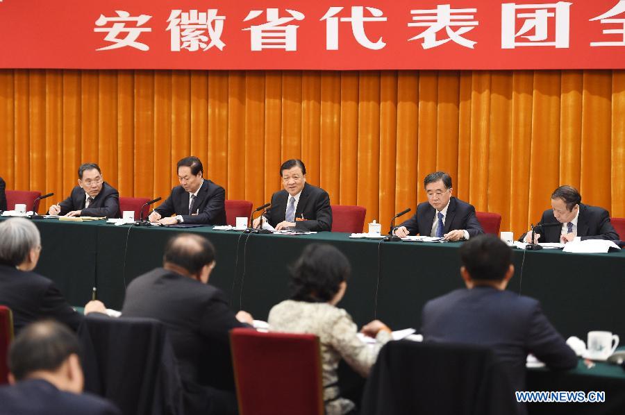 Liu Yunshan (back C), a member of the Standing Committee of the Political Bureau of the Communist Party of China (CPC) Central Committee and secretary of the Secretariat of the CPC Central Committee, joins a panel discussion of deputies to the 12th National People's Congress (NPC) from east China's Anhui Province, in Beijing, capital of China, March 7, 2015. (Xinhua/Xie Huanchi) 