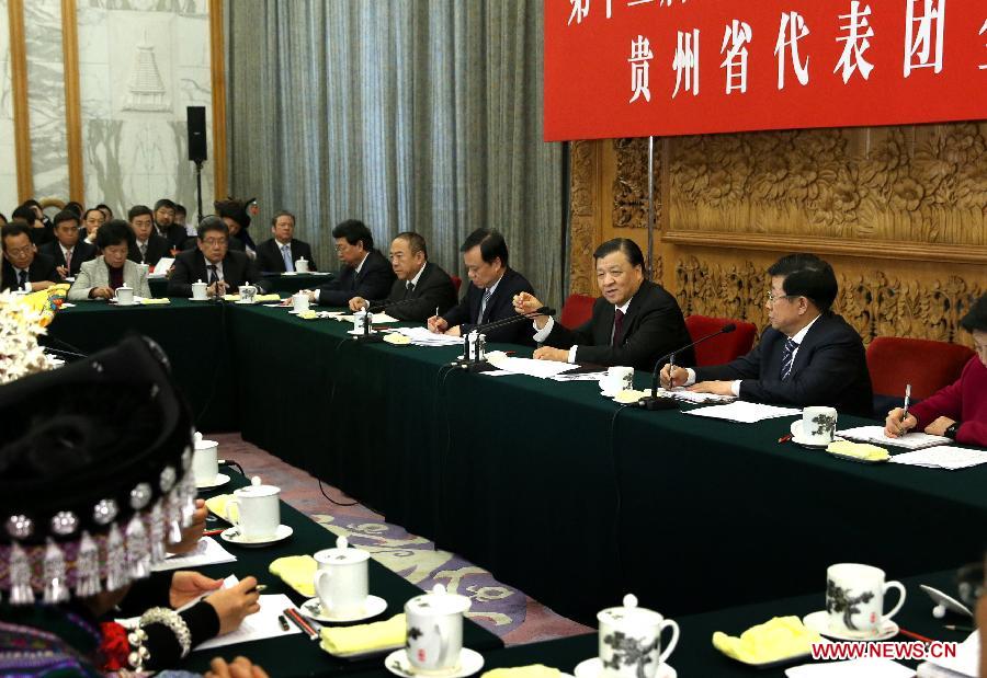 Liu Yunshan (back, 3rd R), a member of the Standing Committee of the Political Bureau of the Communist Party of China (CPC) Central Committee and secretary of the Secretariat of the CPC Central Committee, joins a panel discussion of deputies to the 12th National People's Congress (NPC) from southwest China's Guizhou Province during the third session of the 12th NPC in Beijing, capital of China, March 8, 2015.