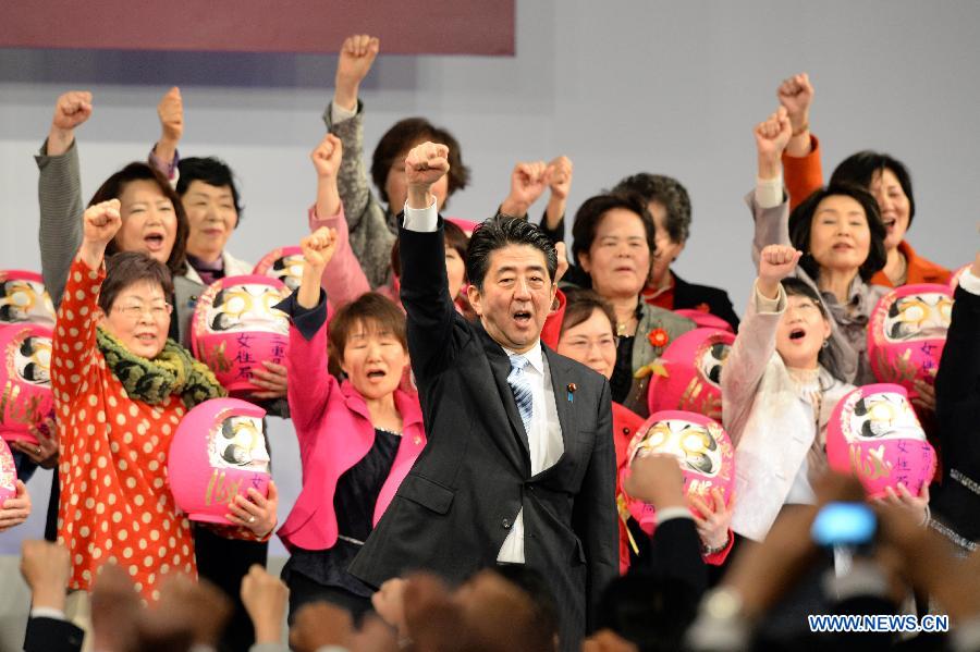 Japanese Prime Minister Shinzo Abe (C, front) shouts slogans with female delegates during the annual convention of the Liberal Democratic Party (LDP), in Tokyo, Japan, March 8, 2015. 