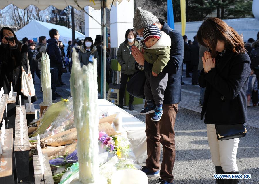 People offer prayers during a memorial service marking the 4th anniversary of the 2011 earthquake and tsunami that pummeled the eastern sea board and left more than 18,000 people dead or missing, in Tokyo, Japan, on March 11, 2015.