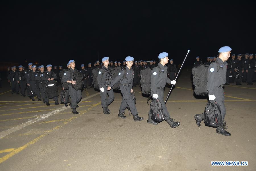 Police officers of the third Chinese riot police squad to join a UN peacekeeping mission in Liberia arrive at an airport in Monrovia, Liberia on March 11, 2015. 