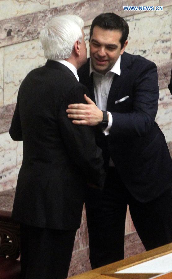 Newly elected Greek President Prokopis Pavlopoulos(L) hugs Greek Prime Minister Alexis Tsipras during a swearing-in ceremony inside the parliament in Athens, Greek, on March 13, 2015.