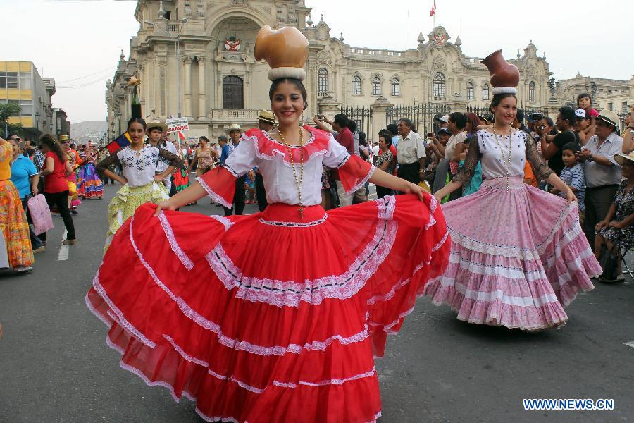 Paraguayan dancers perform during the 'Parade of the World Cultures' in the framework of the 8th International Meeting of Folklore 'My Peru 2015', in Lima city, capital of Peru, on March 14, 2015.