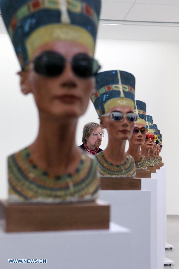 A visitor admires art works during the press view of the exhibition 'Isa Genzken. New Works' at the Museum for Modern Art in Frankfurt, Germany, on March 12, 2015. The exhibition will be held from March 14 to May 31.