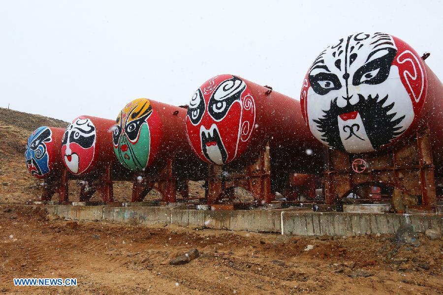 Photo taken on March 4, 2015 shows several oil tanks with painting of Peking Opera Facial Make-up at Zhongshan Station, a Chinese scientific research base in Antarctica. Chinese icebreaker Xuelong, or Snow Dragon, began its return journey on Monday after an over three-month expedition in Antarctica.