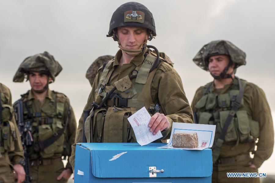 An Israeli soldier casts his ballot two days early at an army base on the Golan Heights, close to the border with Syria, on March 15, 2015.