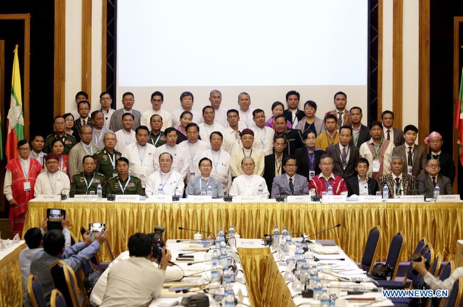 Myanmar President U Thein Sein (C front), members of Myanmar government's Union Peace-Making Work Committee (UPWC) and the ethnic armed groups' National Ceasefire Coordination Team (NCCT) pose for a group photo during a signing ceremony of draft of the nationwide ceasefire agreement (NCA) between members of Myanmar government's UPWC and the ethnic armed groups' NCCT at the Myanmar Peace Center in Yangon, Myanmar, March 31, 2015. 