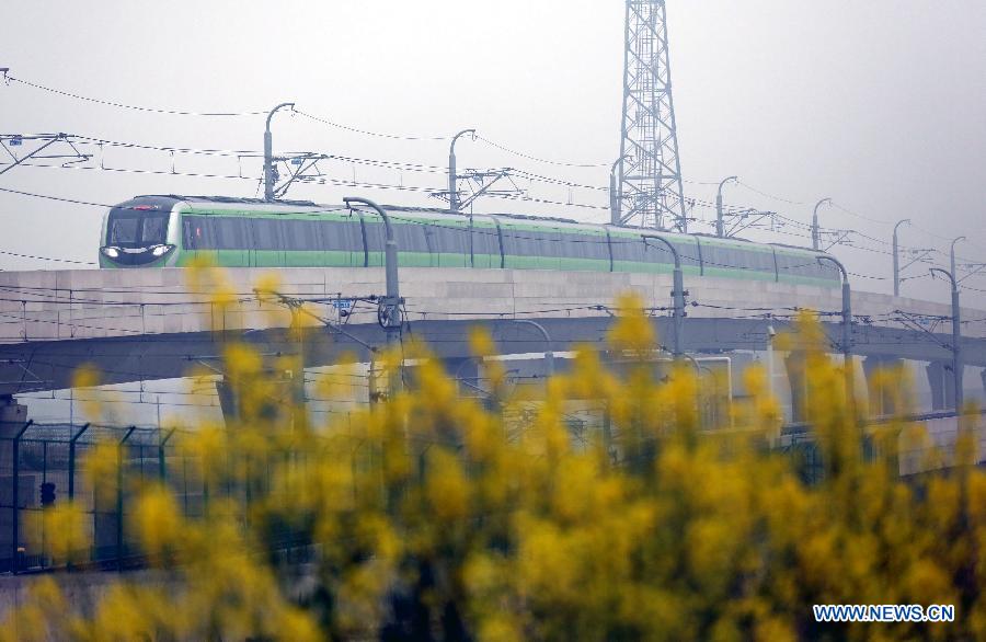 A subway train of the Subway Line 3 draws out of the Linchang Station in Nanjing, capital of east China's Jiangsu Province, April 1, 2015. The 44.87-kilometer-long Subway Line 3 in Nanjing was put into trial operation on Wednesday, making the total length of the city's subway reach 225 kilometers, the fourth longest in China. (Xinhua/Yan Minhang)  