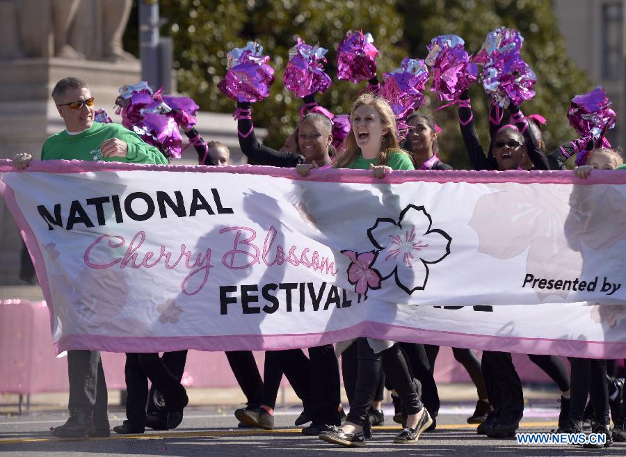 People attend the annual Cherry Blossom Festival Parade along the Constitution Avenue in Washington D.C., capital of the United States, April 11, 2015.