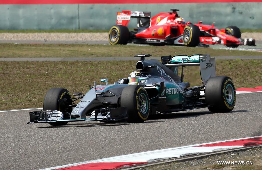 Mercedes AMG driver Lewis Hamilton (bottom) of Britain drives during the Chinese Formula One Grand Prix at Shanghai International Circuit in Shanghai, China, April 12, 2015.