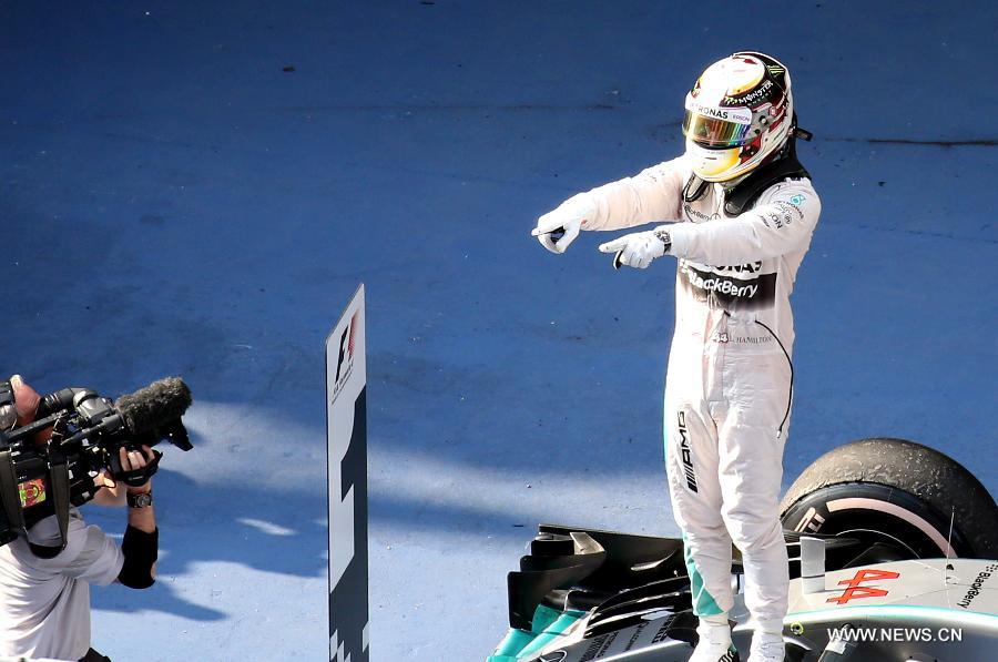 Mercedes AMG driver Lewis Hamilton of Britain celebrates after winning the Chinese Formula One Grand Prix at Shanghai International Circuit in Shanghai, China, April 12, 2015.