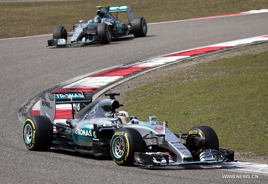 Mercedes AMG driver Lewis Hamilton (bottom) of Britain drives during the Chinese Formula One Grand Prix at Shanghai International Circuit in Shanghai, China, April 12, 2015.