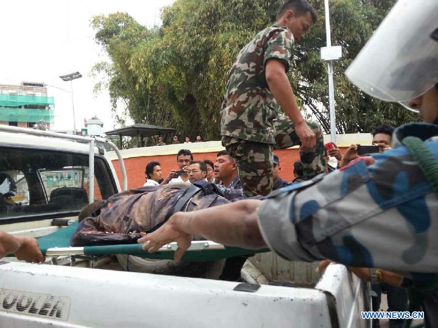 People put a victim's body on a vehicle in Nepal's capital Kathmandu April 25, 2015. 