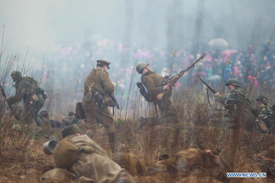 Members from a military club reproduce parts of the Berlin battle in 1945 to mark the 70th anniversary of the victory of the World War II in St. Petersburg, Russia, April 26, 2015. 