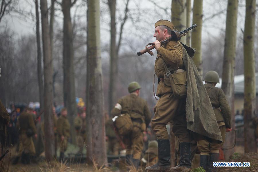 Members from a military club reproduce parts of the Berlin battle in 1945 to mark the 70th anniversary of the victory of the World War II in St. Petersburg, Russia, April 26, 2015.