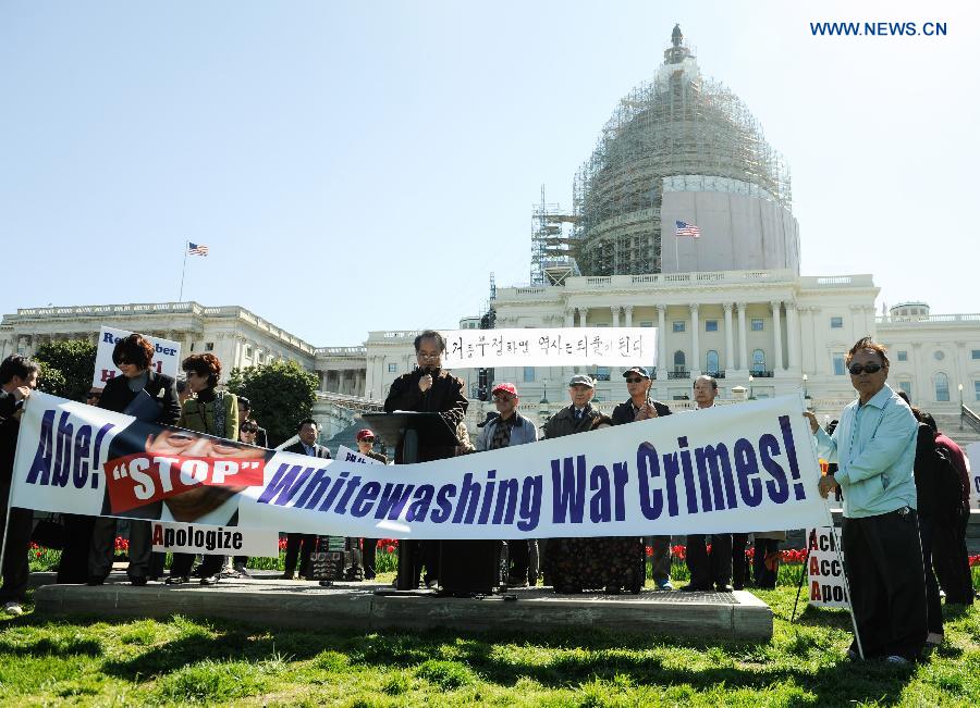 Nearly 200 people held signs and shouted slogans in a protest against Abe's handling of history issues, demanding the Japanese leader to unequivocally apologize for his country's wartime crimes here on Tuesday.