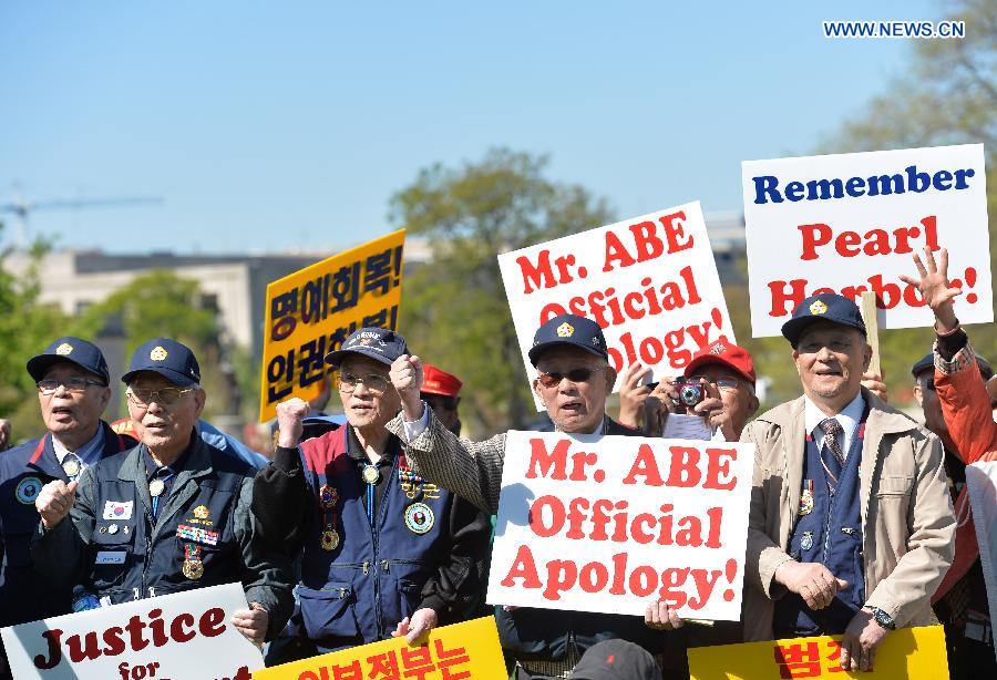 Nearly 200 people held signs and shouted slogans in a protest against Abe's handling of history issues, demanding the Japanese leader to unequivocally apologize for his country's wartime crimes here on Tuesday.