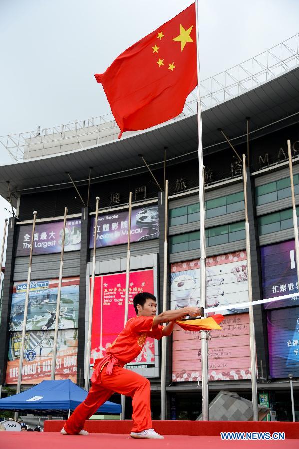 A student performs martial arts during a national flag-raising ceremony in Macao, south China, May 4, 2015. More than 1,000 people including representatives of 43 schools and 19 youth communities and Macao SAR officials on Monday took part in the national flag-raising ceremony to celebrate the Chinese Youth Day marking the May 4th Movement that happened on May 4, 1919, ushering in the new-democratic revolution in China. (Xinhua/Cheong Kam Ka) 