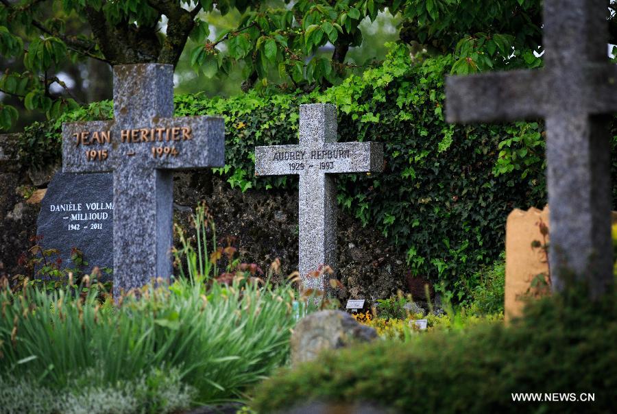 The tomb stone of actress Audrey Hepburn (C) is seen in a ceremety in Tolochenaz village in Switzerland, May 4, 2015. 