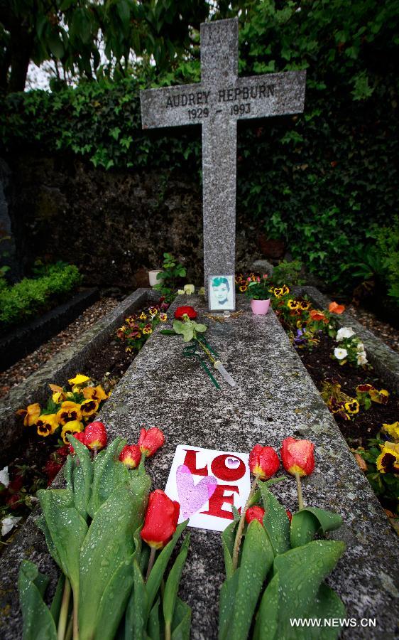 Flowers are placed at the grave of actress Audrey Hepburn in Tolochenaz village in Switzerland, May 4, 2015.