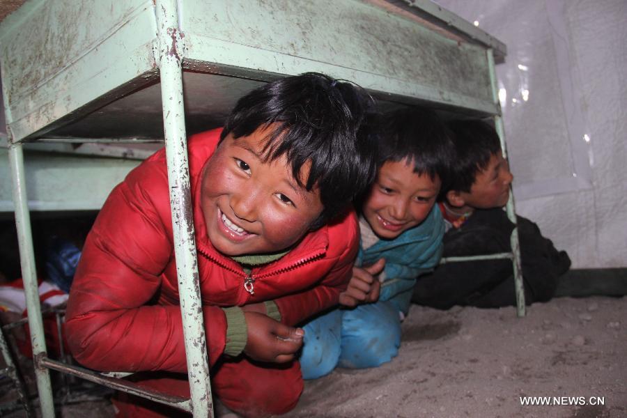 Pupils take part in an earthquake drilling in a tent school in Rongxar Township of Tingri County, southwest China's Tibet Autonomous Region, May 4, 2015.