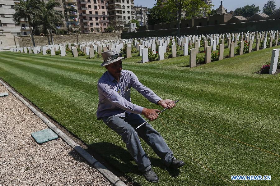 A gardener prepares to mow the grass field at a World War II memorial cemetery in Cairo, Egypt, on May 5, 2015, ahead of the 70th anniversary of the victory of the world anti-Fascism war. (Xinhua/Cui Xinyu) 