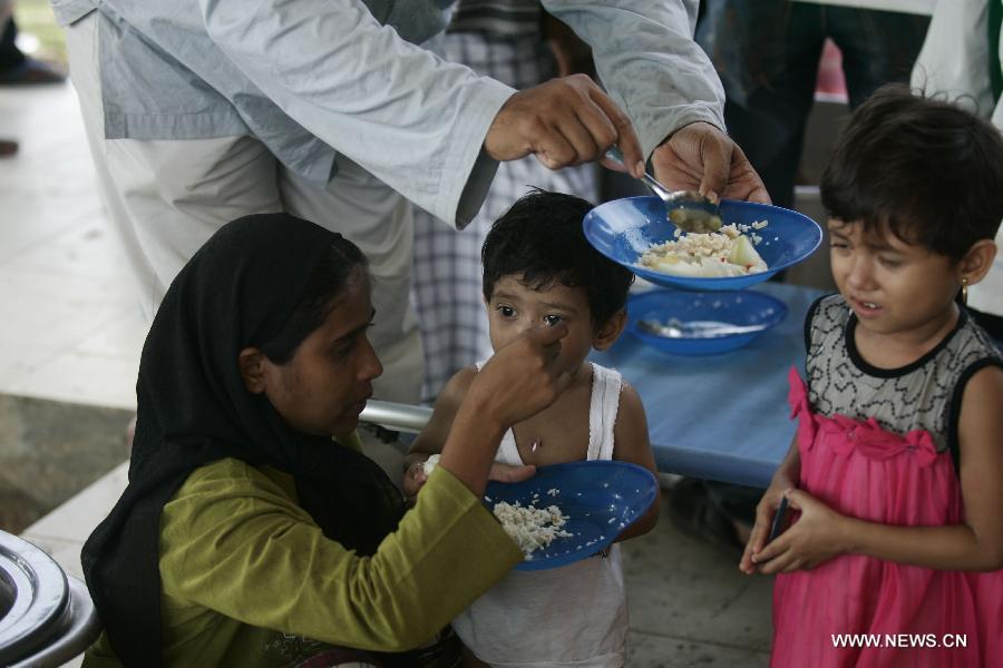 Nearly 600 boat people from Myanmar and Bangladesh stranded in northwest Indonesia moved to a larger shelter today, where migrant groups expect they could spend months before having their claims processed. 