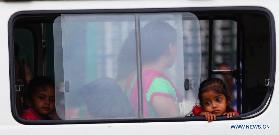 Children take a micro bus with their parents to return to their home in Kathmandu, Nepal, May 16, 2015.