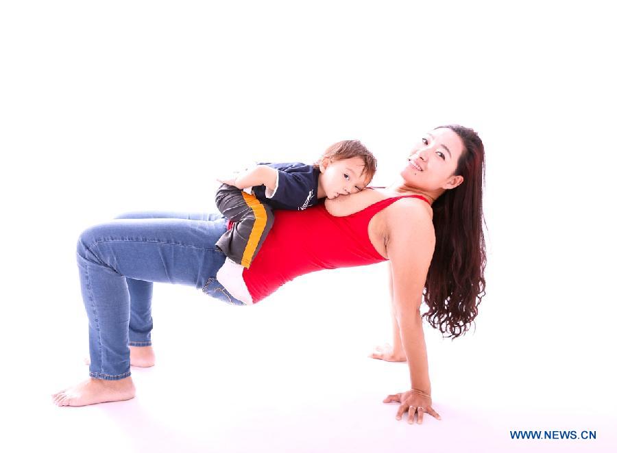 Photo provided by La Leche League-China shows a mother breastfeeding her child. May 20 is China's National Breastfeeding Awareness Day. As the pronounciation of '520' is close to 'I Love You,' many mothers feel meaningful to have their breastfeeding photos to make public. La Leche League-China, a branch of an international organization that provides mother-to-mother support, information and encouragment for breastfeeding, has collected art photos of breastfeeding mothers for three consecutive years. (Xinhua/La Leche League-China)  