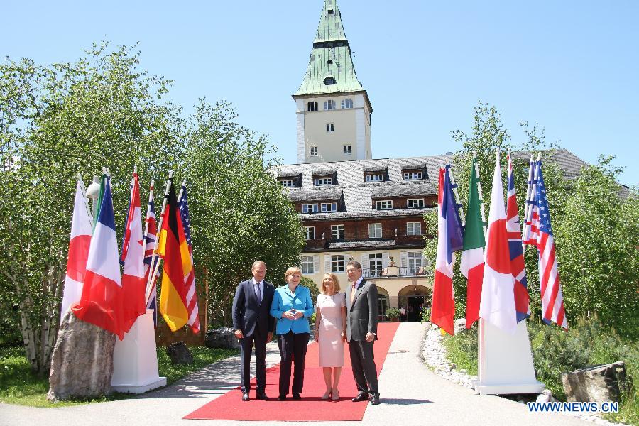 German Chancellor Angela Merkel (2nd L) welcomes President of European Council Donald Tusk (1st L) at the Elmau Castle near Garmisch-Partenkirchen, southern Germany, on June 7, 2015.