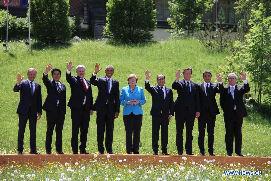 Participants of the G7 summit (L-R) President of the European Council Donald Tusk, Japanese Prime Minister Shinzo Abe, Canadian Prime Minister Stephen Harper, U.S. President Barack Obama, German Chancellor Angela Merkel, French President Francois Hollande, British Prime Minister David Cameron, Italian Prime Minister Matteo Renzi and European Commission President Jean-Claude Junker have a group photo taken at the Elmau Castle near Garmisch-Partenkirchen, southern Germany, on June 7, 2015.