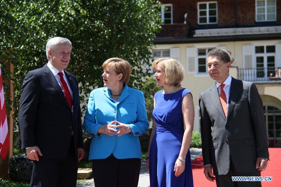 German Chancellor Angela Merkel (2nd L) welcomes Canadian Prime Minister Stephen Harper (1st L) at the Elmau Castle near Garmisch-Partenkirchen, southern Germany, on June 7, 2015. 